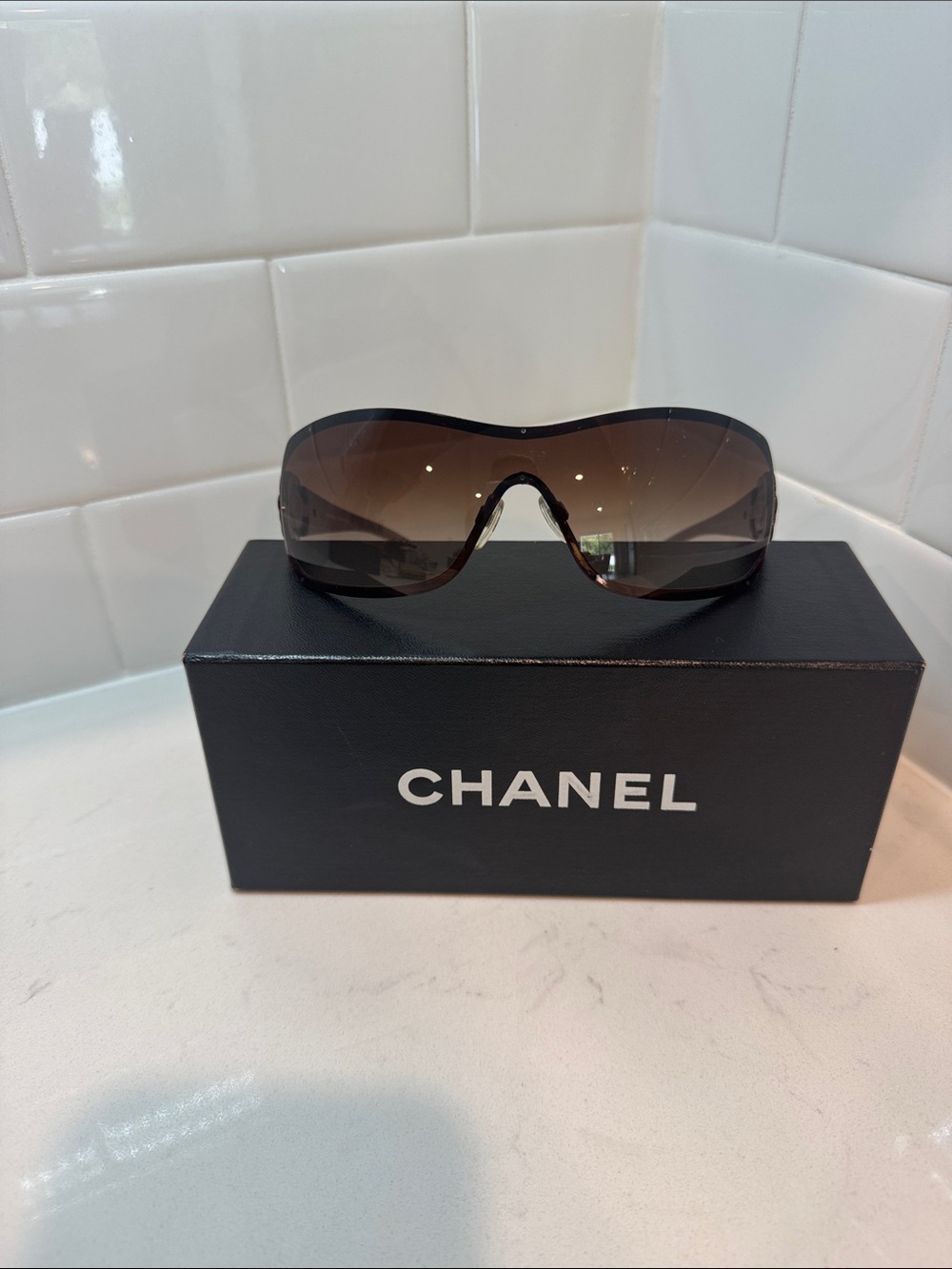 Chanel  Camellia flower with crystal-embellished interlocking CC logo